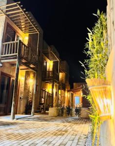 a large building with a patio at night at Maré Mansa Suítes Icaraizinho in Amontada