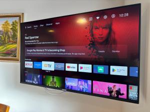 a flat screen tv hanging on a wall at 136 St George Motel in Auckland
