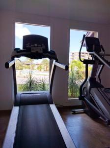 a gym with two exercise bikes and a window at Oasis Aruba Views Just for You! -Newly Refurnished in Oranjestad