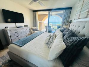 a bedroom with a large bed with a view of the ocean at Oasis Aruba Views Just for You! -Newly Refurnished in Oranjestad +67 photos