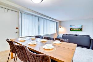 a dining room with a table and chairs and a couch at Modern Apt in Prime Location w Business Facilities in Addison Heights