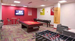 a room with a pool table and a piano at Modern Apt in Prime Location w Business Facilities in Addison Heights