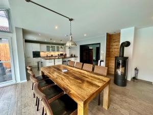 a kitchen and dining room with a wooden table and chairs at AlpenNest Mountain Oasis in Inzell in Inzell