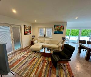 a living room with a couch and a table at AlpenNest Mountain Oasis in Inzell in Inzell