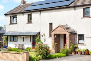a house with solar panels on the roof at B&B Meadow View in Penrith
