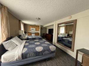 a hotel room with two beds and a mirror at Snowshoe Motel in Frisco