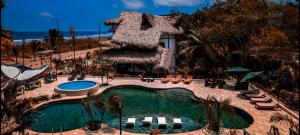 a resort with a swimming pool and a resort at Hostería Mandála in Puerto López