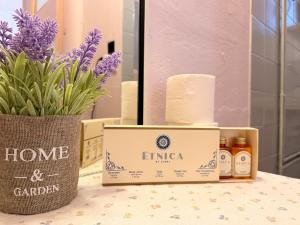 a box of products sitting on a table with flowers at Classic rooms in the center in Loutraki +16 photos