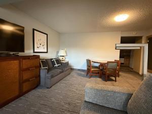 a living room with a couch and a dining room table at Snowshoe Motel in Frisco