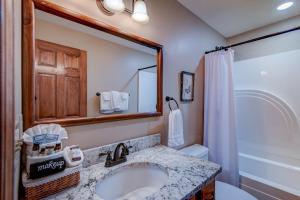 a bathroom with a sink and a mirror and a toilet at Hill Station in Beech Mountain +36 photos