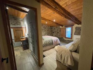 a bedroom with a bed and a couch in a room at Roca negra Montseny in Fogars de Montclus +88 photos