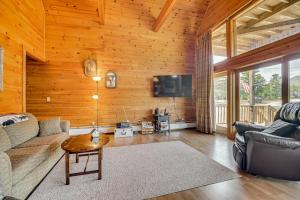 a living room with a couch and a tv at Mountain-View Deck! Cabin By Mt Abraham Trails in Kingfield