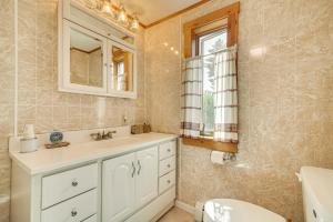 a bathroom with a sink and a toilet and a mirror at Mountain-View Deck! Cabin By Mt Abraham Trails in Kingfield +22 photos