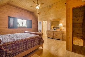 a bedroom in a log cabin with a bed and a sink at Mountain-View Deck! Cabin By Mt Abraham Trails in Kingfield