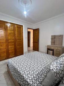 a bedroom with a bed in a white room at Casa youssef 2 in Asilah