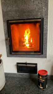 a fireplace with a fire in it with flames at Lapland Lakefront Villa - Winter Wonderland in Ranua