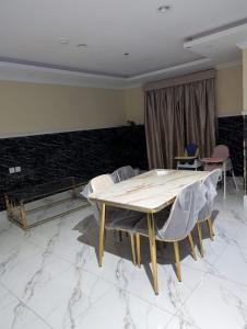 a dining room with a wooden table and chairs at فندق قربان in Al Madinah
