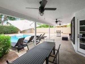 a patio with a table and chairs and a pool at Sereno - Sparkling Pool - Near Scottsdale Quarter in Phoenix