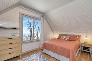 a bedroom with a bed and a large window at Calling Me Home in Blowing Rock