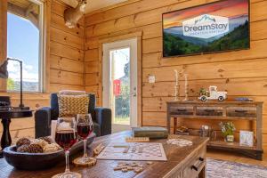 a room with a table with two glasses of wine at Mountain View Splash - Indoor Pool Hot Tub Game Room Stunning Smoky Mountain Views in Wear Valley