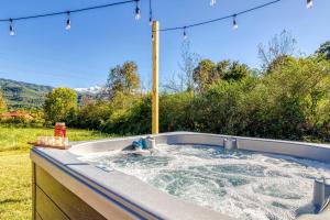 a jacuzzi tub in a backyard with a view at Mountain View Splash - Indoor Pool Hot Tub Game Room Stunning Smoky Mountain Views in Wear Valley