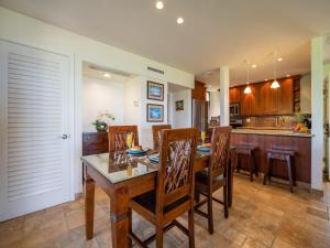 a kitchen and dining room with a table and chairs at Wailea Elua Village 1301 in Wailea +24 photos