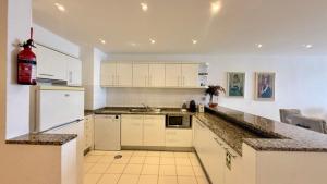 a kitchen with white cabinets and a counter top at Sea Haven in Funchal