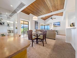 a dining room and living room with a table and chairs at Wailea Elua Village 208 in Wailea +55 photos