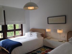 a bedroom with a bed and a window and two lamps at Casa Rural Balerdi in Azcárate