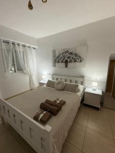 a bedroom with a large bed with towels on it at Benidorm Breeze in Benidorm