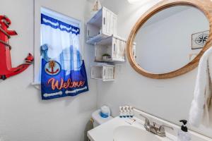 a bathroom with a sink and a mirror at La Mansion SPV6 in Port Aransas +27 photos