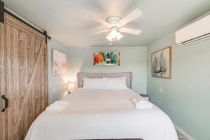a bedroom with a large bed with a ceiling fan at Barefoot Bungalow SPV26 in Port Aransas
