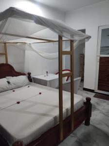 a bedroom with two bunk beds with white sheets at Nils Home in Nungwi
