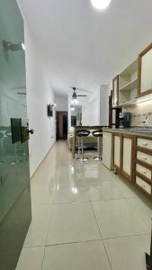 a large kitchen with a table and chairs in it at LU DORMIS 2 - Artigas - Alquiler Temporario in Corrientes