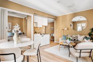 a kitchen and living room with a table and chairs at Barfot Apartment - Bergen City center in Bergen