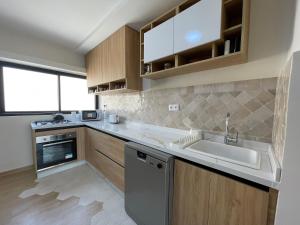 a kitchen with a sink and a dishwasher at Petit Bali 4-5px in Agadir