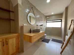 a bathroom with a sink and a toilet and a mirror at Petit Bali 4-5px in Agadir +52 photos