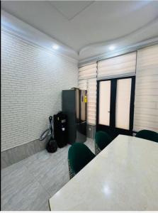 a meeting room with a table and green chairs at Guesthouse Anora 1, Three minutes walk from Registan Square, The very Center of Samarkand in Samarkand