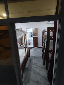 a room with two bunk beds and a refrigerator at Nils Home in Nungwi