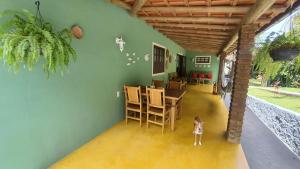a dog standing in the middle of a living room at Pousada Casa Franco - Trancoso in Trancoso