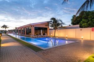 a swimming pool in front of a building at Arubas Life 207 in Noord