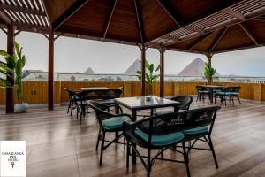 a group of tables and chairs on a patio at Casablanca pyramids inn in Cairo