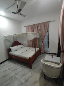 a bedroom with a bed and a bathtub and a bath tub at Nils Home in Nungwi +22 photos