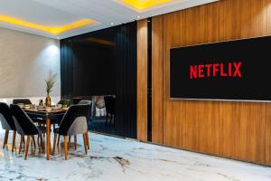 a dining room with a netflix sign on a wall at Modern Luxury Villa Heart of Central agadir in Agadir +13 photos