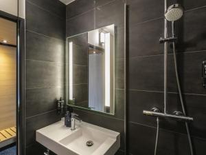 a bathroom with a sink and a mirror at ibis Nancy Centre Stanislas in Nancy +24 photos