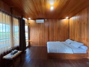 a bedroom with a bed and a wooden wall at D88 Resort in Remboken +16 photos