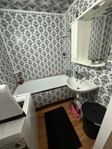 a bathroom with a sink and a bath tub at Apartmán Šurany in Šurany +15 photos