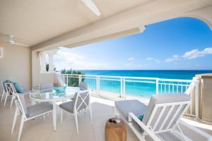 a dining room with a view of the ocean at Beachcomber 35 in George Town