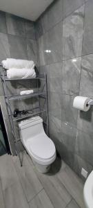 a bathroom with a toilet and towels on a shelf at Casa rayón 1 in Tuxpan +19 photos