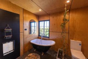 a bathroom with a large tub and a toilet at Ocean View Escape in Sandy Beach